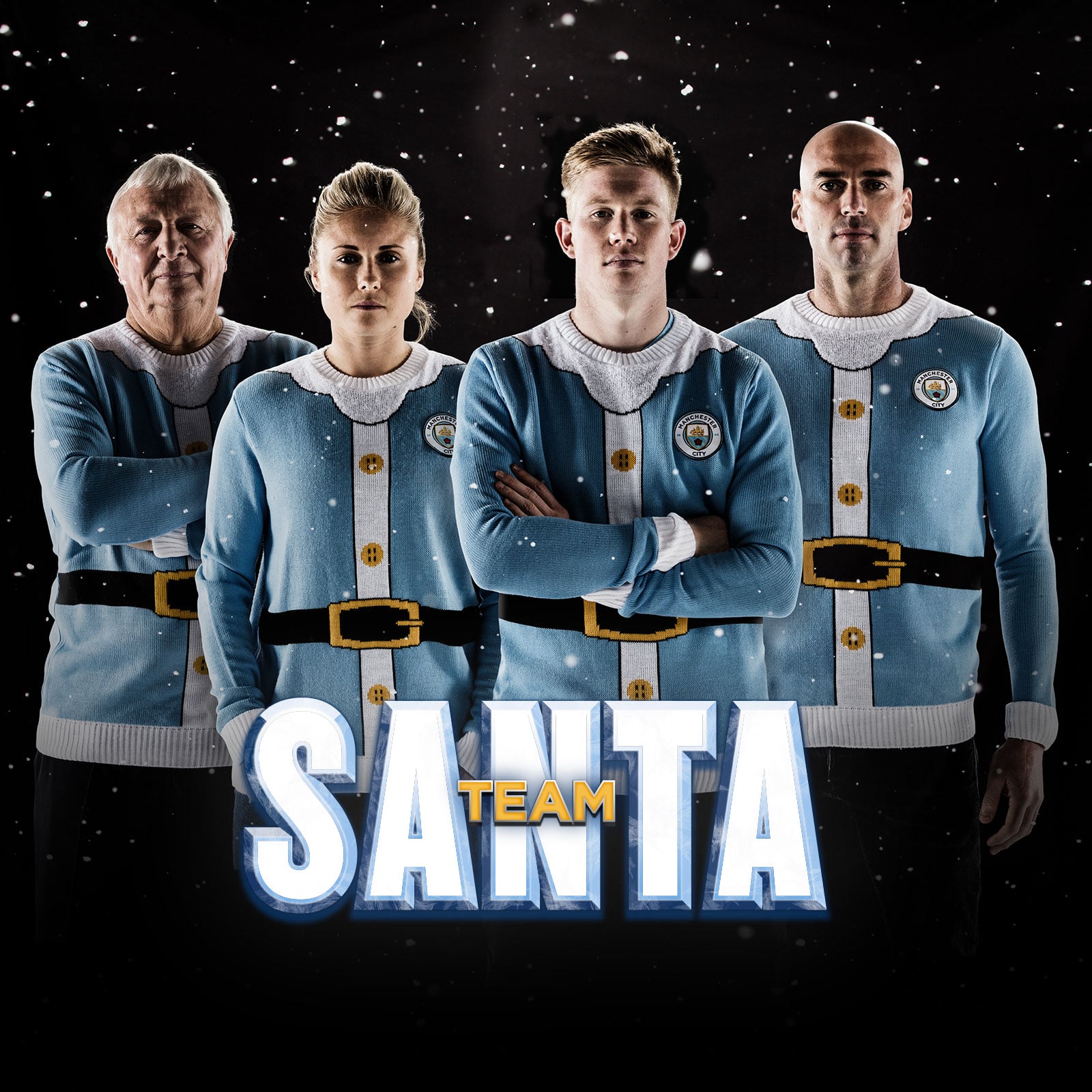 A photograph of Team Santa, Kevin De Bruyne stood at the front with his arms folded across his body. Behind him Steph Houghton, Willy Caballero and Mike Summerbee. Snow is falling over a black background behind them