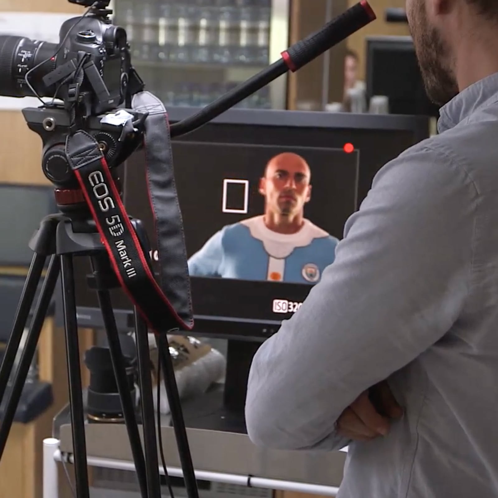 A member of the video team stood back from his camera to watch a clip he has just recorded of Willy Caballero from the Manchester City team in his Santa jumper