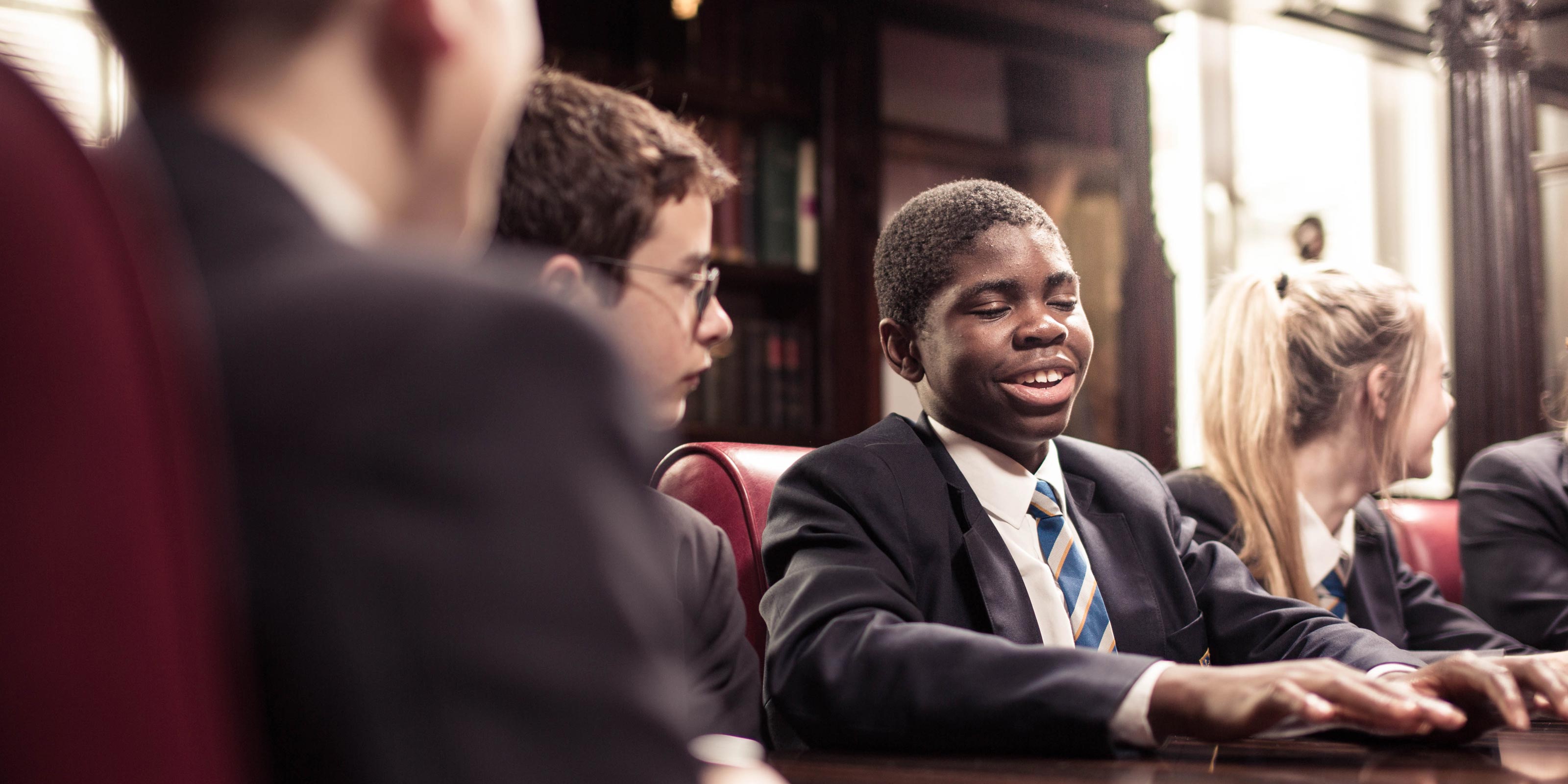 Group of senior students chatting around a desk