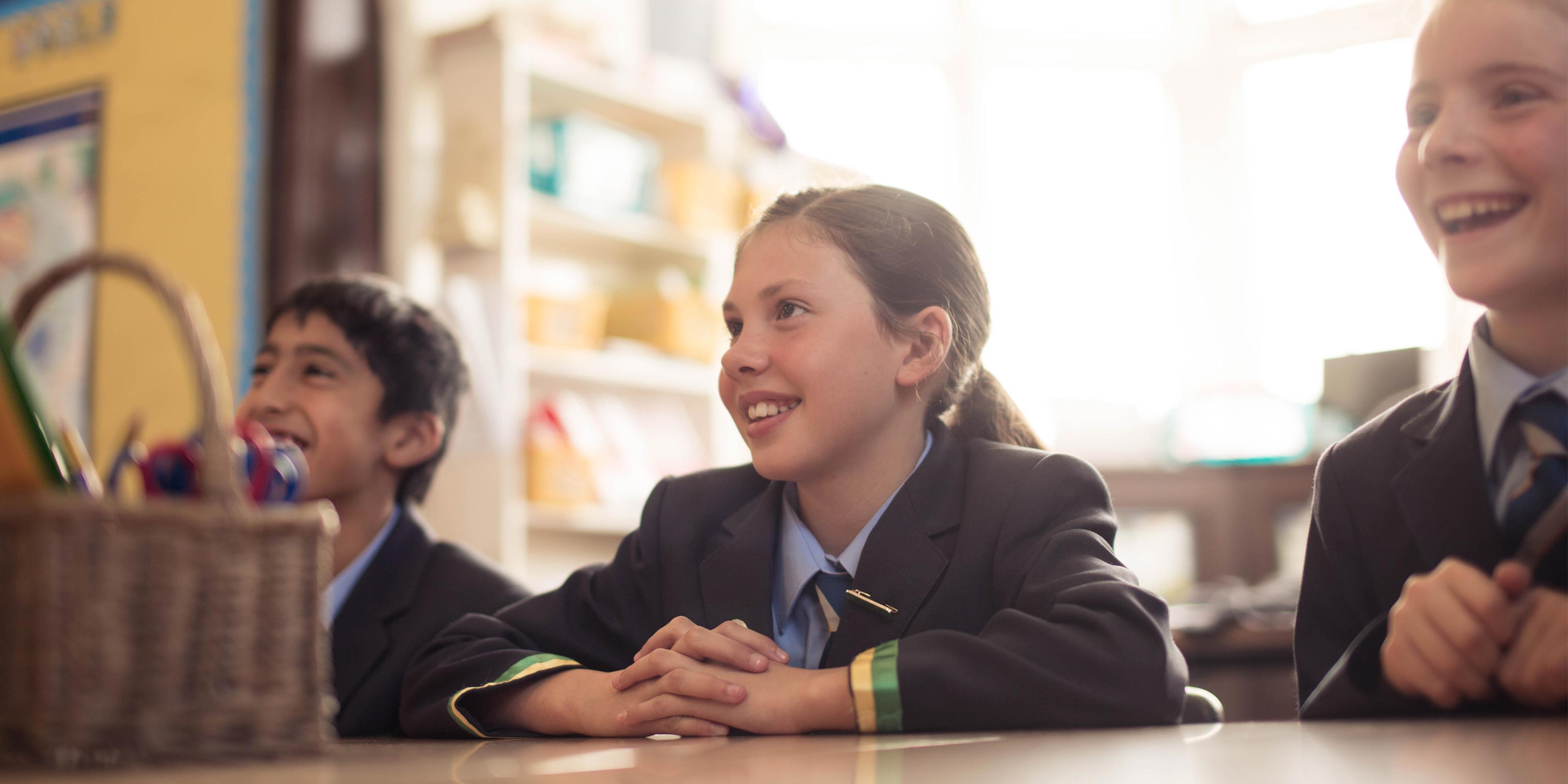 Group of senior students chatting around a desk