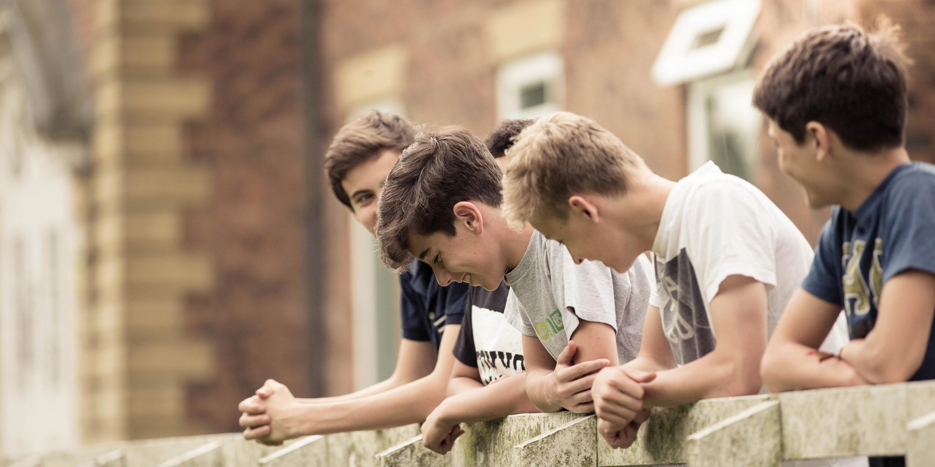 Group of male students socialising in the school grounds