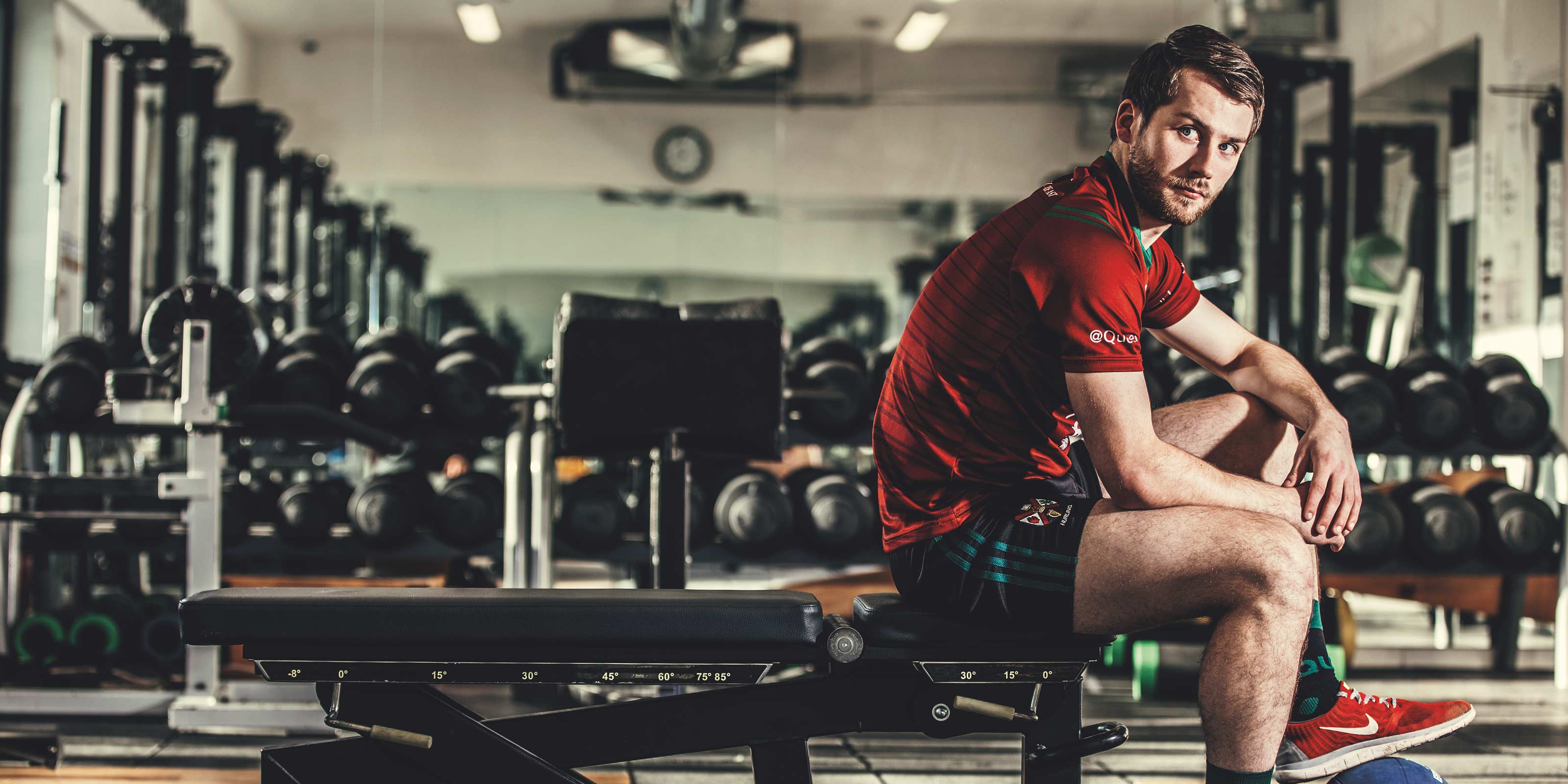 QUB hockey player in the gym