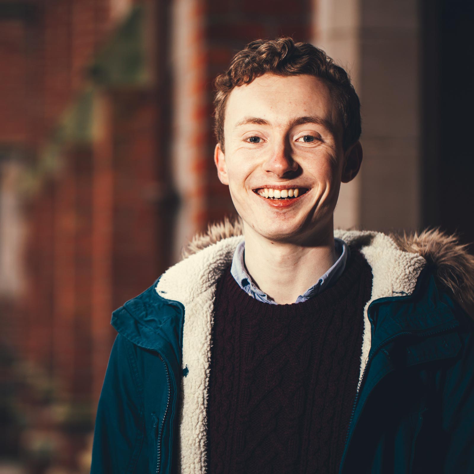 Young male undergraduate in the cloisters at QUB