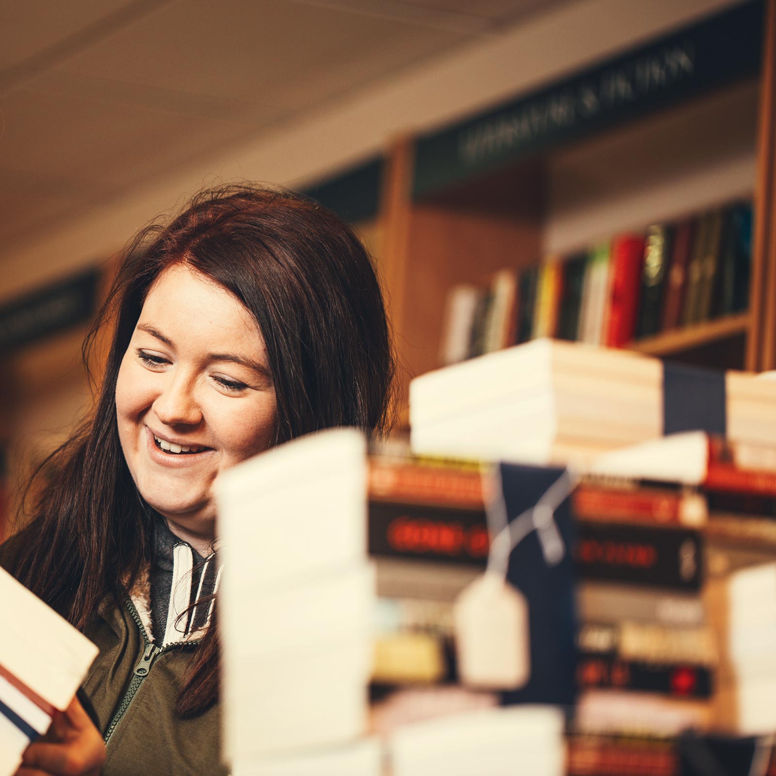 Young female undergraduate in the student union bookshop at QUB