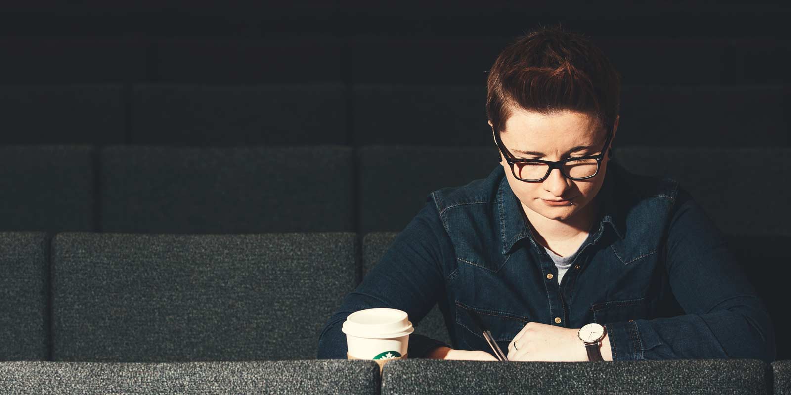 QUB student working in lecture theatre